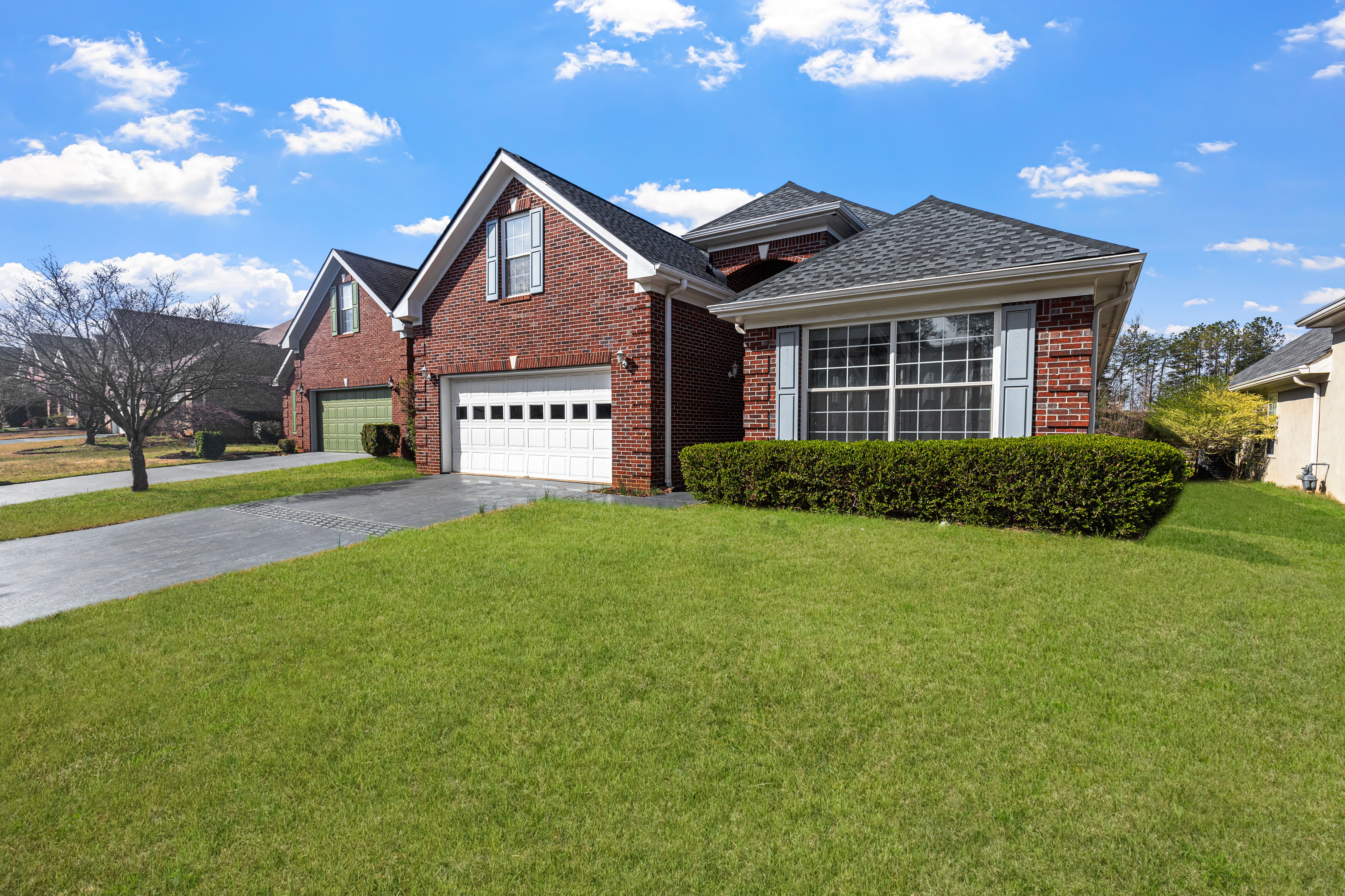 Brick home with a freshly maintained lawn